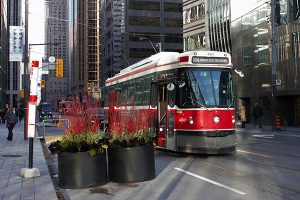 A streetcar stops on King Street in Toronto. A section of the busy east-west street travelling through downtown Toronto has restricted car traffic, and U of T Engineering researchers are collaborating with the City of Toronto and the Toronto Transit Commission to study the pilot project’s effects. (Credit: Billy Cabic via Flickr under creative commons license)