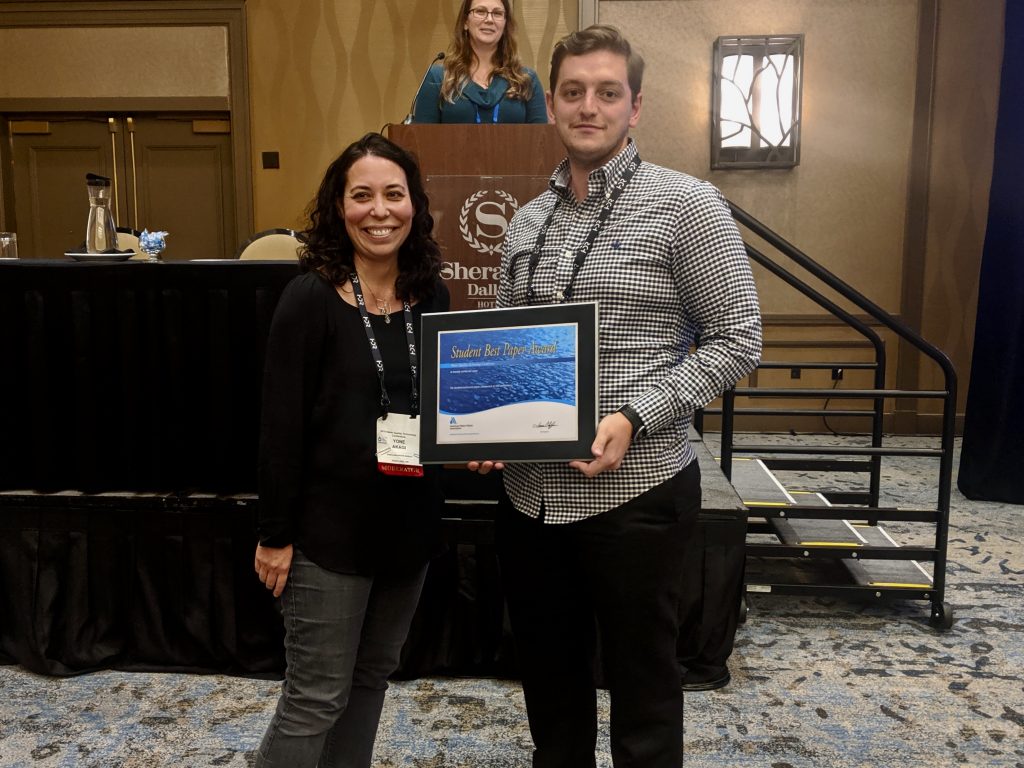 Sam Cherniak (MASc Candidate) accepts the American Water Works Association Best Student Award from Yone Akagi, Water Quality Manager with the Portland, Oregon Water Bureau AWWA member and awards judge, while at the AWWA Water Quality Technology Conference in Dallas, TX on Wednesday, November 6, 2019.   He won the award for his work "Towards a Standardized Sampling and Analysis Protocol for Microplastics in Drinking Water." Photo: Husein Almuhtaram/ Drinking Water Research Group.