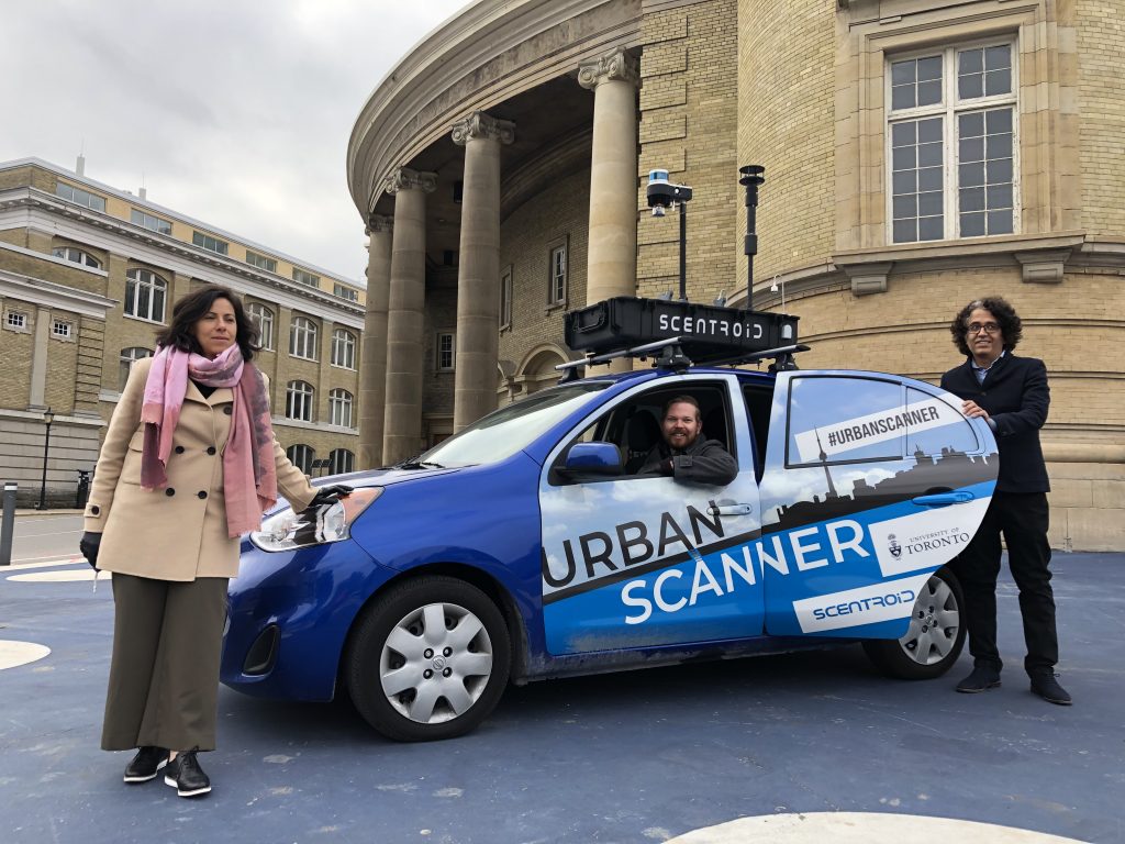 three researchers post with outfitted "Urban Scanner" car