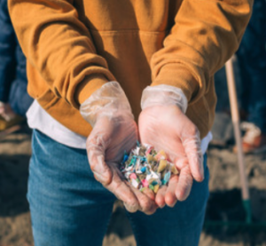 A person holding microplastics collected from a nearby water supply