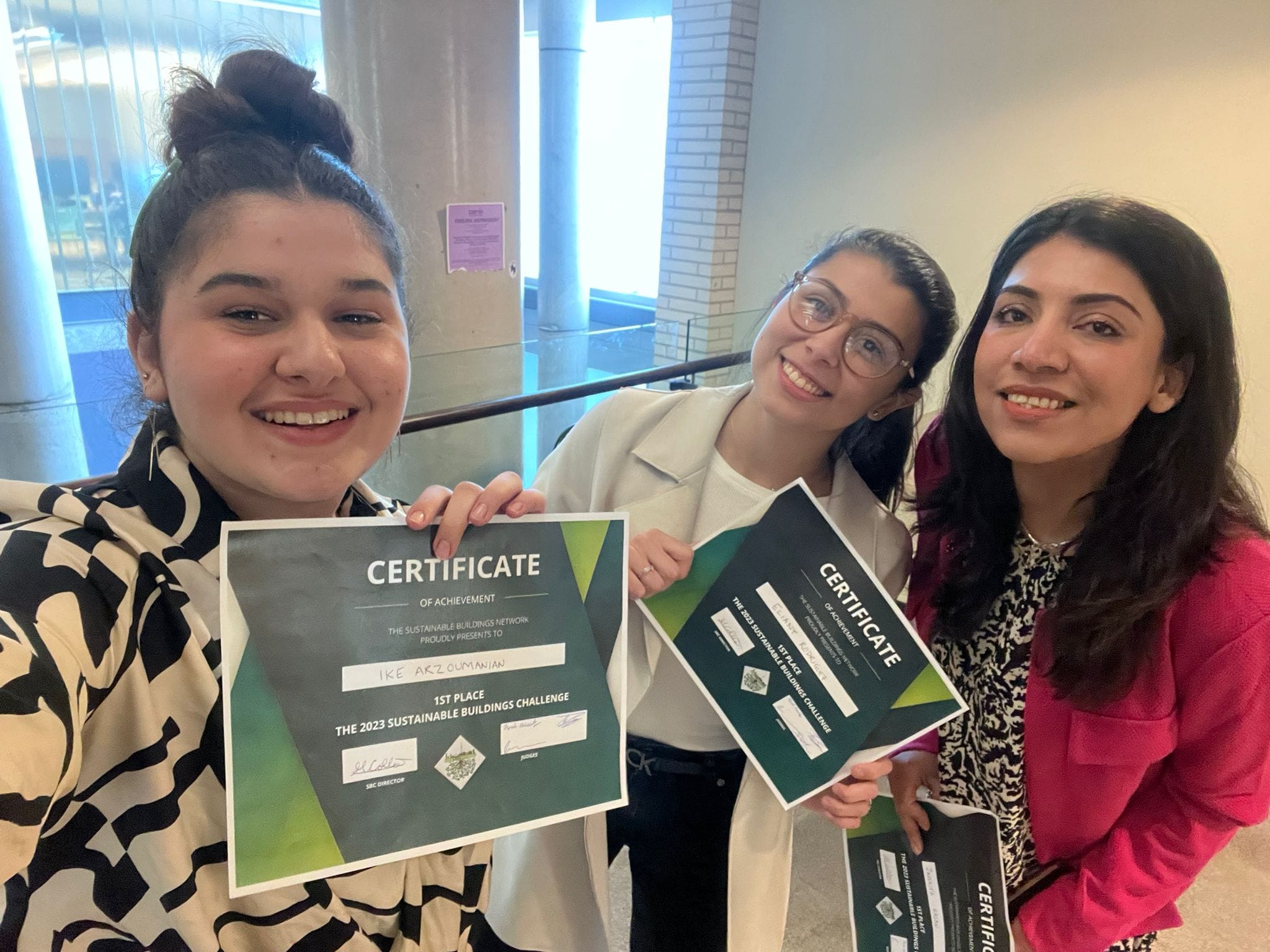 Ike Arzoumanian (CivE 2T5) -left, Eliany Rodriguez, Javeriya Hasan smiling and showing their certificates.