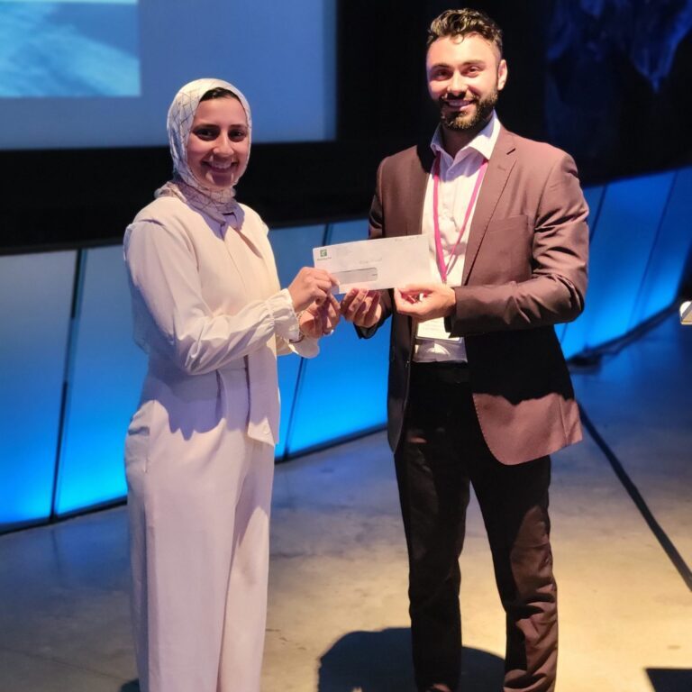 Alia Galal (L) receives CARSP Best Poster Award from Robert Colonna (R), CARSP Young Professionals Committee Chair, at CARSP Conference 2022, June 20, 2022. (Photo: Peter Kehoe)