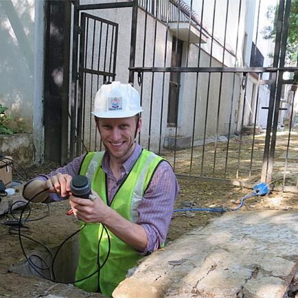 Professor David Taylor checking on his pressure, flow, and turbidity sensors in a valve chamber in Delhi, India. (Photo courtesy David Taylor)