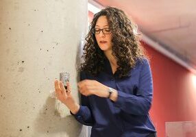Professor Fae Azhari (MIE, CivE) holds a sample of the self-sensing concrete she designed. Her work helps monitor the structural health of crucial infrastructure such as bridges, roads and hydroelectric dams. (Credit: Roberta Baker)
