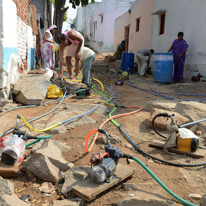 With utilities in countries such as India running water infrastructure intermittently to minimize water lost to leaky pipes, many residents use pumps to draw as much water as they can when it is available (photo by Noah Seelam/AFP via Getty Images)