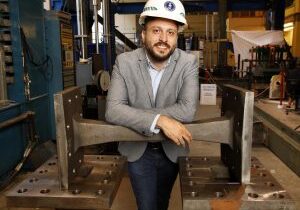 TORONTO: JULY 18, 2019 --  PEDRAM MORTAZAVI -- Civ PhD Candidate Pedram Mortazavi, MASc, P.Eng, poses with a cast steel EBF in the Structures Lab at the University of Toronto's Department of Civil &amp; Mineral Engineering in Toronto on Thursday, July 18, 2019. His thesis is titled: Cast Steel Replaceable Link Elements in Steel Eccentric Braced Frame (EBF), and is designed to allow a specific piece of a building structure fail in an earthquake so as to allow the structure to remain intact. The sacrificial piece is designed to be standardized and replaceable afterwards. 
PHOTO: Phill Snel, Department of Civil &amp; Mineral Engineering/ U of T