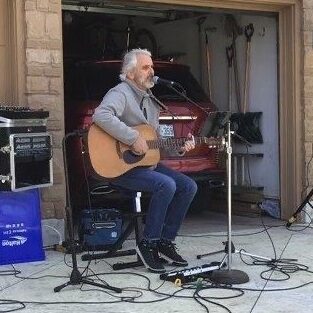 Joe Tiernay plays guitar by his garage as his Kick Kovid to the Kurb Koncert. (Photo courtesy Joe Tiernay)