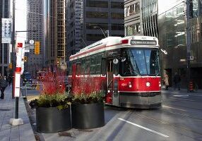 A streetcar stops on King Street in Toronto. A section of the busy east-west street travelling through downtown Toronto has restricted car traffic, and U of T Engineering researchers are collaborating with the City of Toronto and the Toronto Transit Commission to study the pilot project’s effects. (Credit: Billy Cabic via Flickr under creative commons license)