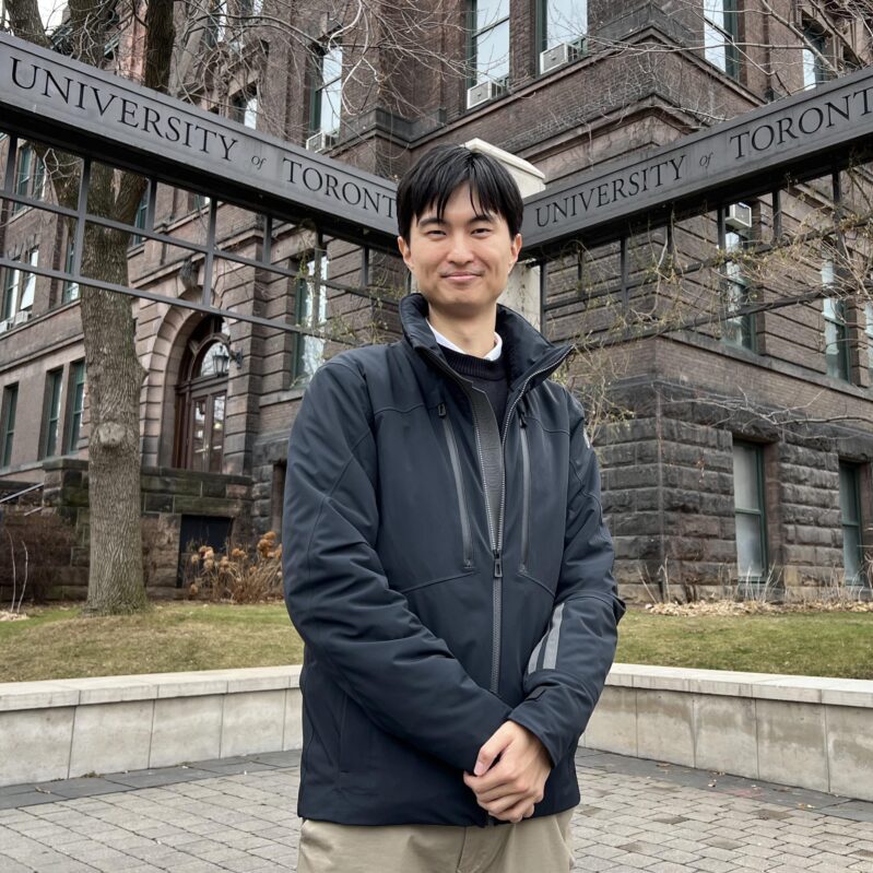 Professor Minghan Xu stands in front of the U of T gates by the Lassonde Mining Building. (Photo by Phill Snel)