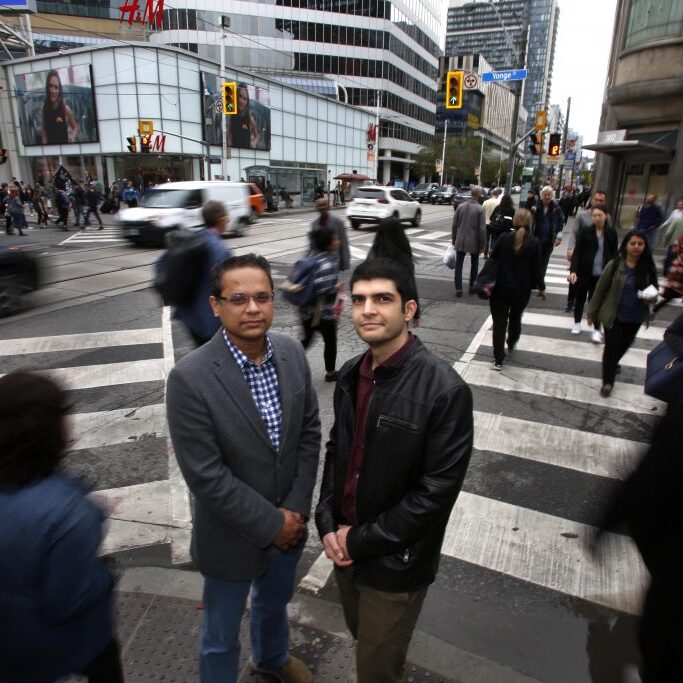  Sina Azizi Soldouz, a MASc candidate (R) and supervisor Professor Khandker Nurul Habib (Lt) pose for a photo at Yonge Street and Dundas Street in downtown Toronto on Tuesday, June 10, 2019. A survey of pedestrians with sight loss was conducted in collaboration with the Canadian National Institute for the Blind (CNIB) under the title Understanding the impact of connected and automated vehicles for pedestrians with sight loss – a policy framework.
PHOTO: Phill Snel, Department of Civil &amp; Mineral Engineering/ U of T