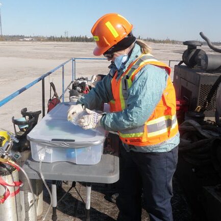 Professor Lesley Warren performs environmental sampling at Syncrude Canada’s Base Mine Lake, an important location for mining-impact water research and technology development in Alberta’s Oil Sands. (Photo courtesy Lesley Warren)